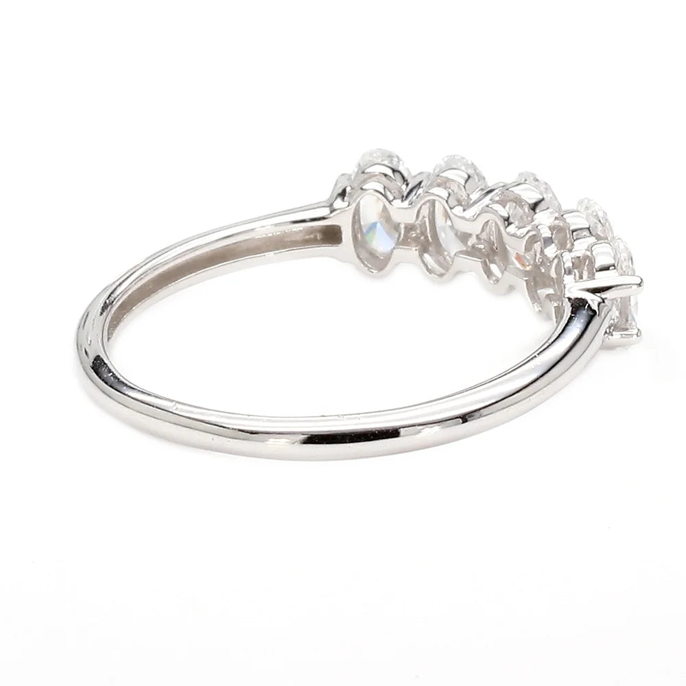A silver-colored ring featuring a curved band with a row of small clear stones at the top, photographed on a plain white background.