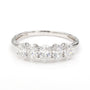 A five-stone diamond ring in a polished silver-colored metal band, featuring five oval-cut diamonds set in a row. The inside of the band is marked '14K', indicating the gold content.