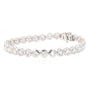 A silver tennis bracelet featuring round-cut clear gemstones in a classic link design, displayed on a clean white background.