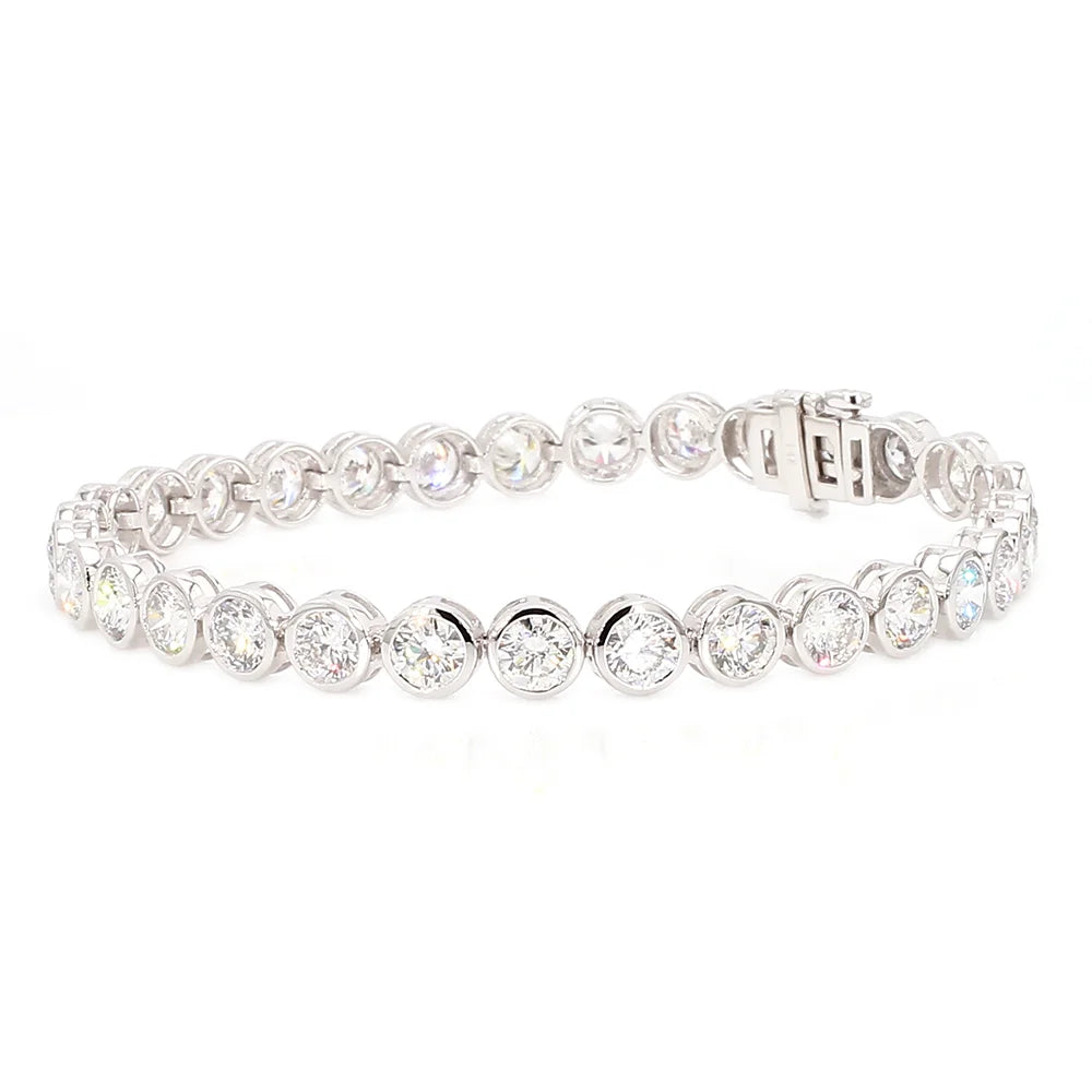 A silver tennis bracelet featuring round-cut clear gemstones in a classic link design, displayed on a clean white background.