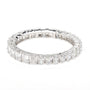 A silver-toned eternity ring featuring a continuous row of baguette and round-cut clear gemstones, photographed on a seamless white background.