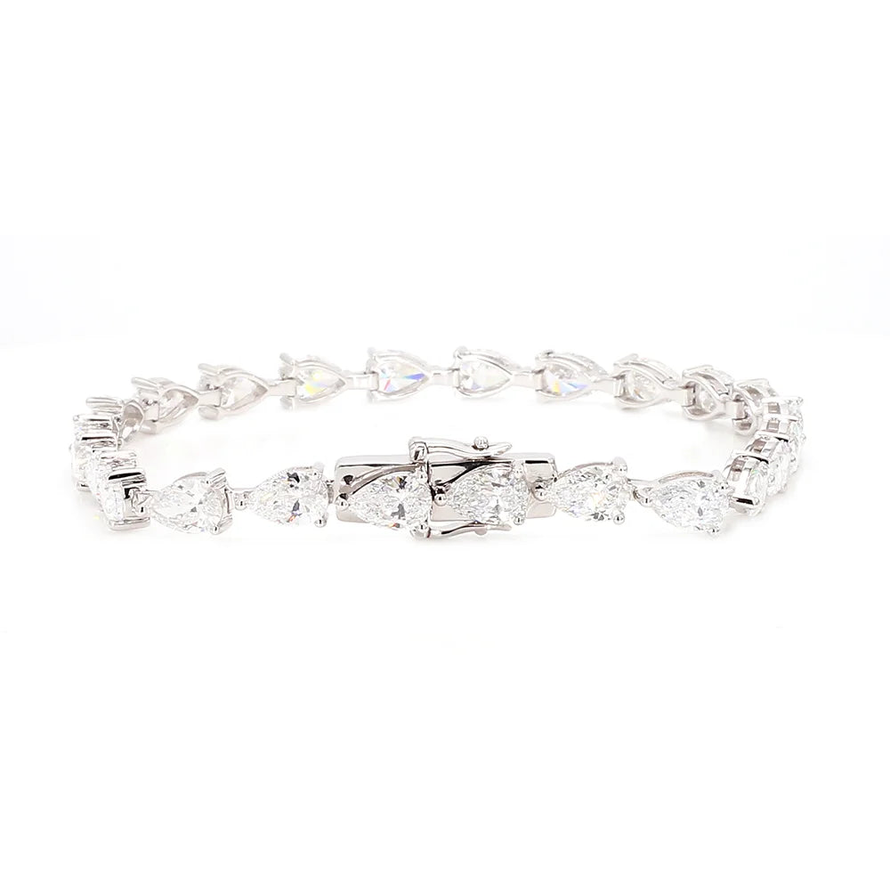 A silver tennis bracelet featuring a continuous link design of marquise and pear-cut clear gemstones, displayed on a solid white background.