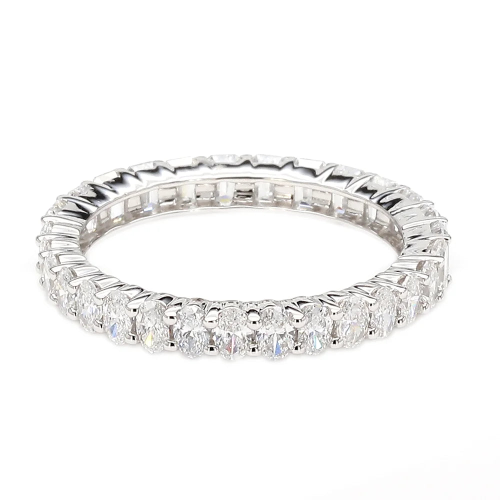 A silver-toned eternity ring featuring a continuous row of round brilliant-cut diamonds and baguette-cut diamonds, set against a plain white background.