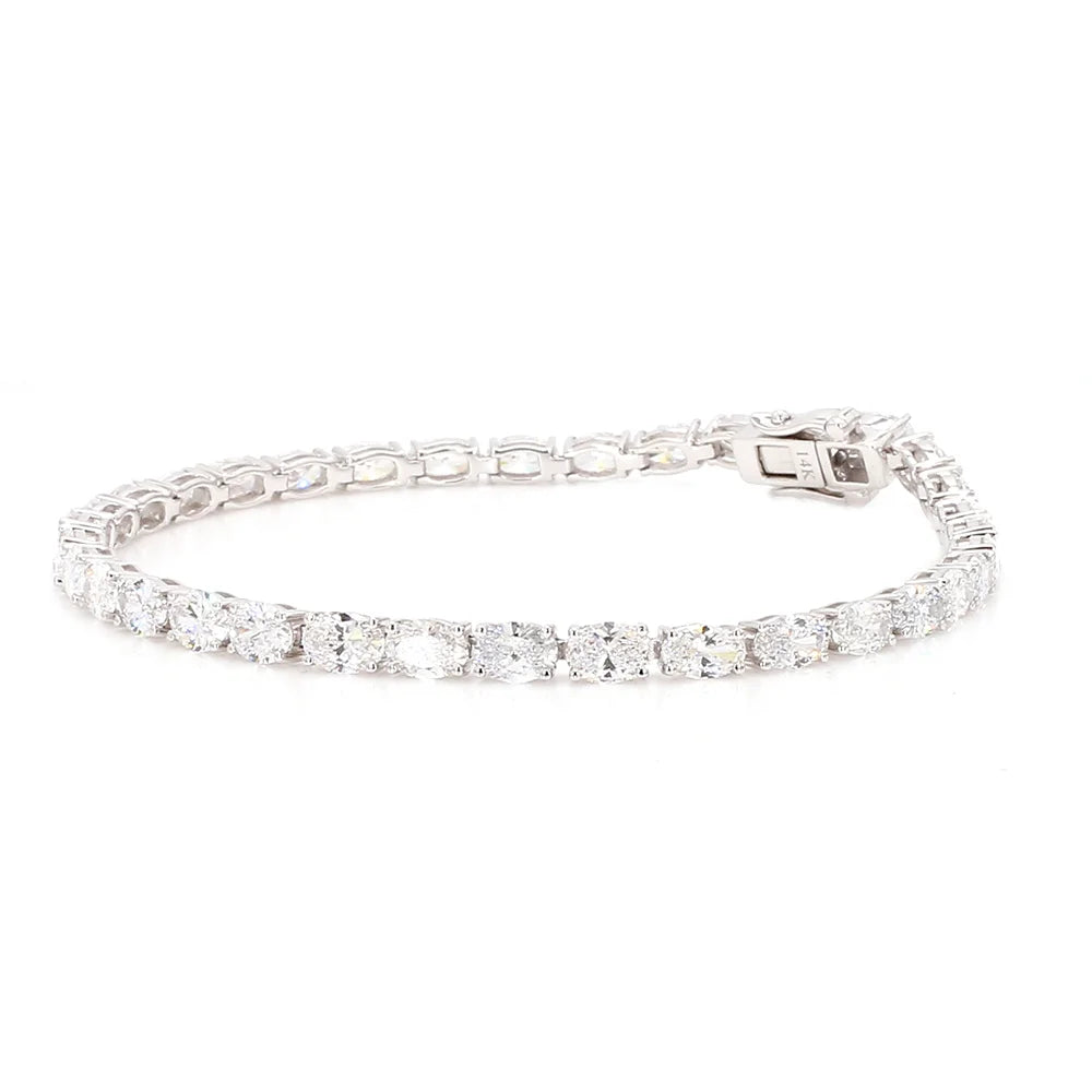 A silver tennis bracelet paved with round clear stones, shown against a plain white background.