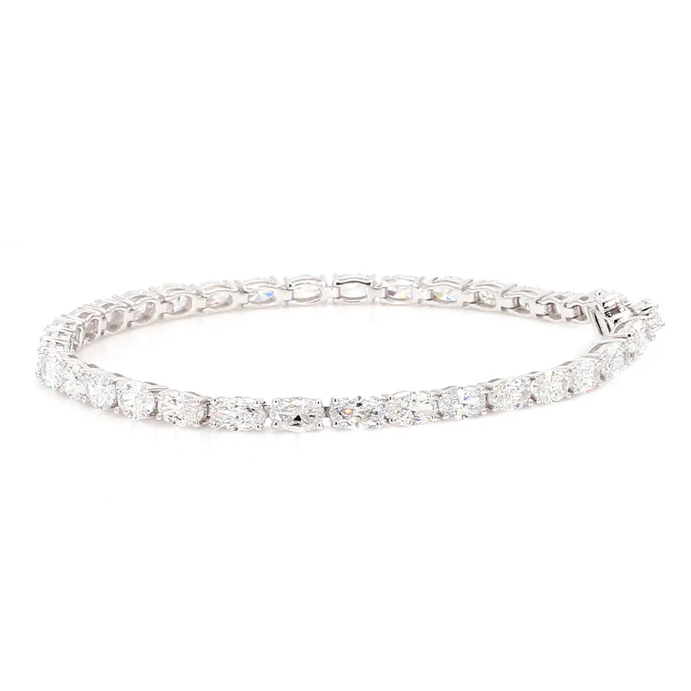A white gold tennis bracelet featuring a continuous row of round brilliant-cut diamonds in a classic link design, shown against a plain white background.