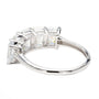 A silver-colored ring featuring a row of baguette-cut clear gemstones in a prong setting, shown on a plain white background.