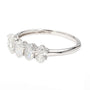 A silver five-stone diamond ring featuring marquise, oval, and round-cut diamonds on a polished band, with a 14K hallmark visible inside.