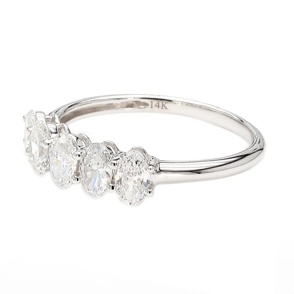 A silver five-stone diamond ring featuring marquise, oval, and round-cut diamonds on a polished band, with a 14K hallmark visible inside.