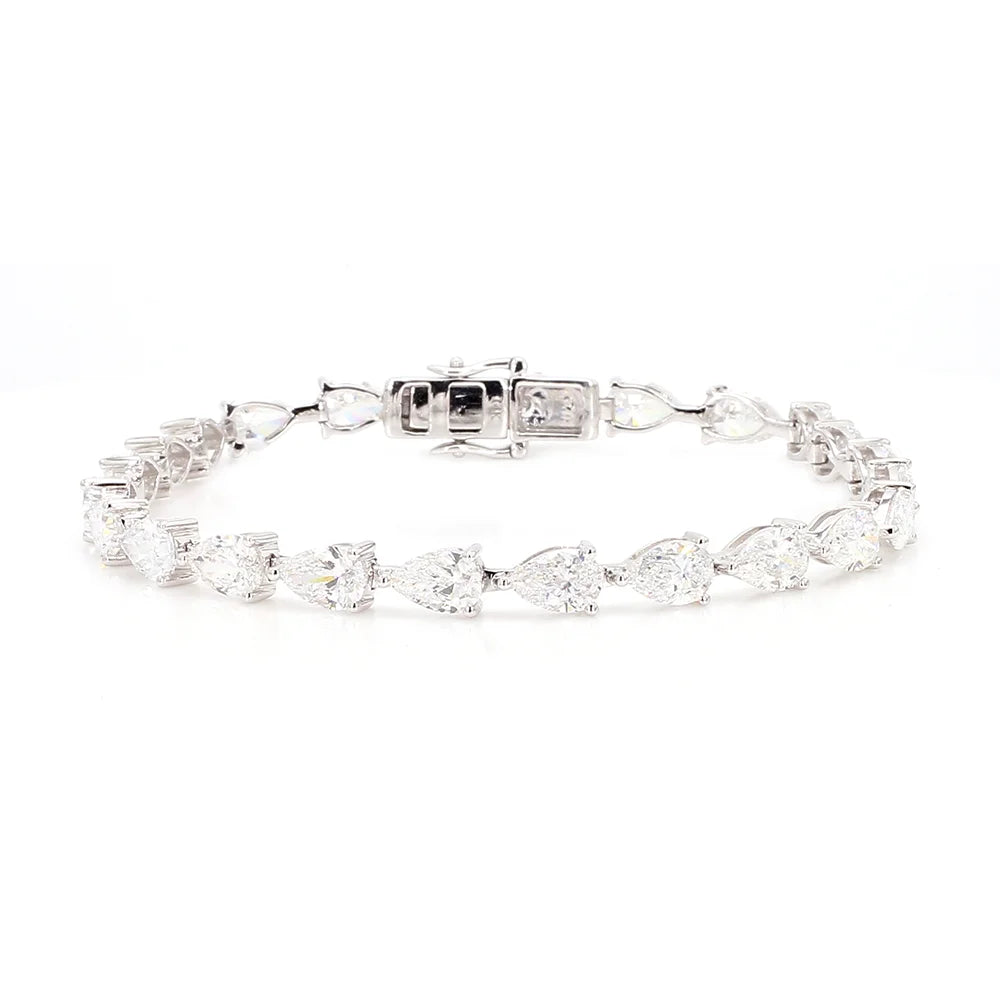 A silver tennis bracelet featuring marquise and round-cut clear gemstones, displayed on a clean white background.