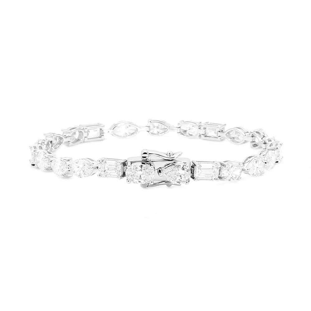 A silver tennis bracelet featuring a central cluster of baguette and round-cut clear stones, photographed on a solid white background.