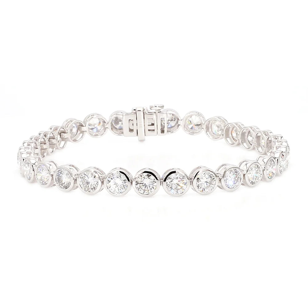 A silver tennis bracelet featuring a row of round-cut clear gemstones in bezel settings, displayed on a clean white background.