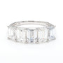A silver band ring featuring a row of baguette-cut clear gemstones, photographed on a clean white background.