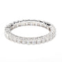 A silver-toned eternity ring featuring a continuous line of baguette and round-cut clear gemstones, photographed on a seamless white background.