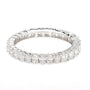 A silver-toned eternity ring featuring a continuous row of baguette and round-cut clear gemstones, shown on a plain white background.