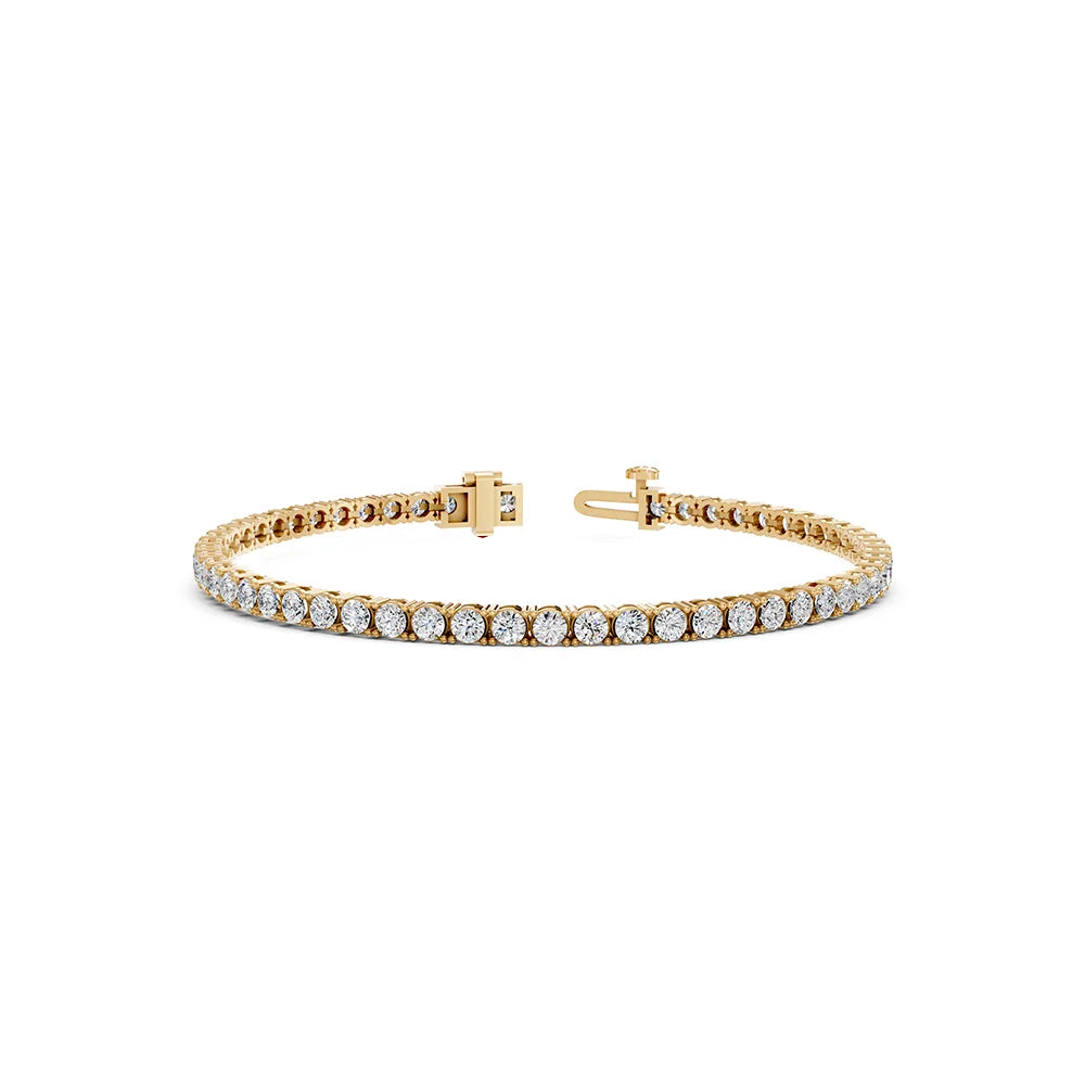 A gold tennis bracelet with a continuous row of clear round-cut gemstones, displayed on a clean white background.