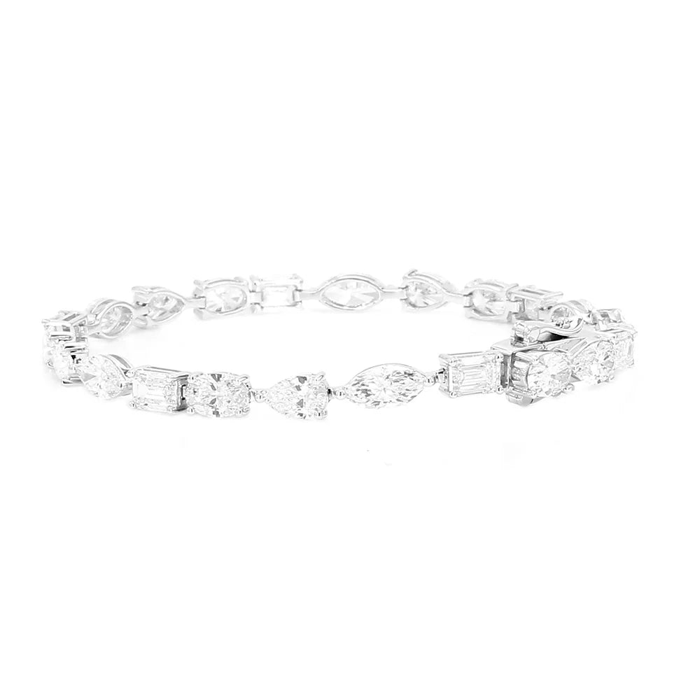 A silver-toned diamond tennis bracelet featuring a mix of baguette, round, and marquise-cut diamonds, displayed against a solid white background.