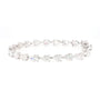 A silver tennis bracelet featuring a continuous line of clear pear-cut and round-cut gemstones on a white background.