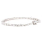 A diamond tennis bracelet with a brilliant link design and a small matching diamond accent on the clasp, set in a silver-colored metal, shown against a plain white background.