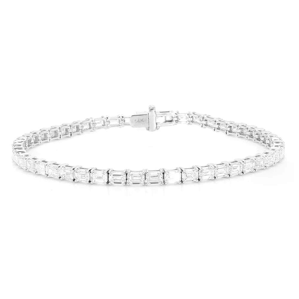 A silver tennis bracelet featuring baguette-cut clear gemstones in a continuous row, displayed on a clean white background.