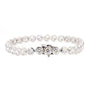A silver-toned tennis bracelet featuring round brilliant-cut clear stones in a continuous link design, with a central clasp, shown on a plain white background.